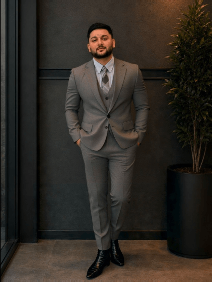 Before: a man in a grey three-piece suit and tie